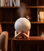 دستگاه بخور سرد پایه چوبی طرح گنجشک با چراغ خوابLED 🐦 مرطوب‌کننده هوای USB 🐦 دستگاه بخور سرد و شب‌خواب طرح گنجشک؛ ترکیبی از زیبایی، آرامش و رطوبت‌رسانی اگر به دنبال یک دستگاه بخور سرد رومیزی با طراحی زیبا و کاربردی هستید، دستگاه بخور سرد پایه چوبی طرح گنجشک انتخابی ایده‌آل برای اتاق خواب، میز کار، اتاق کودک یا محل کار است. این محصول علاوه بر ایجاد رطوبت مناسب در محیط، با چراغ خواب LED چندرنگ جلوه‌ای آرامش‌بخش و دکوراتیو به فضای شما می‌بخشد. ✨ مخزن 300 میلی‌لیتری، عملکرد بی‌صدا، تغذیه از طریق USB و قابلیت تغییر رنگ نور LED، این دستگاه را به گزینه‌ای مناسب برای استفاده روزانه، سفر و هدیه تبدیل کرده است. ⭐ ویژگی‌های محصول ✅ طراحی زیبا با پایه چوبی و طرح گنجشک ✅ دستگاه بخور سرد و مرطوب‌کننده هوا ✅ مخزن آب با ظرفیت 300 میلی‌لیتر ✅ دارای چراغ خواب LED هفت‌رنگ با نور سفید گرم و تغییر رنگ ✅ تغذیه از طریق کابل USB ✅ عملکرد فوق‌العاده بی‌صدا ✅ دارای خاموش شدن خودکار برای افزایش ایمنی ✅ مناسب برای منزل، محل کار، خودرو، اتاق کودک و سفر ✅ کمک به حفظ رطوبت مناسب محیط و کاهش خشکی هوا 📌 مشخصات فنی نام محصول: دستگاه بخور سرد پایه چوبی طرح گنجشک نوع: مرطوب‌کننده هوای رومیزی (Humidifier) ظرفیت مخزن: 300 میلی‌لیتر منبع تغذیه: USB نوع نور: LED هفت‌رنگ با نور سفید گرم قابلیت‌ها: تغییر رنگ نور، خاموش شدن خودکار، عملکرد بی‌صدا کاربرد: بخور سرد، شب‌خواب، دکور اتاق، مرطوب‌کننده هوا 💡 چرا این محصول را انتخاب کنیم؟ خشکی هوا می‌تواند باعث خشکی پوست، گلو و مجاری تنفسی شود. دستگاه بخور سرد طرح گنجشک با تولید مه سرد، به حفظ رطوبت مناسب محیط کمک کرده و فضای اتاق را دلپذیرتر می‌کند. همچنین نورپردازی LED چندرنگ، این محصول را به یک چراغ خواب دکوراتیو زیبا تبدیل کرده که برای اتاق خواب، میز کار و اتاق کودک بسیار مناسب است. 🛍️ خرید از خرازی آرامیس در خرازی آرامیس می‌توانید انواع دستگاه بخور سرد، چراغ خواب LED، وسایل دکوری و محصولات متنوع را با قیمت مناسب تهیه کنید. همچنین با عضویت در کانال ایتای خرازی آرامیس می‌توانید جدیدترین محصولات را مشاهده کرده و کد رهگیری مرسوله‌های ارسالی خود را دریافت کنید. 📢 کانال ایتا خرازی آرامیس: https://eitaa.com/kharraziaramis 🔍 کلمات کلیدی دستگاه بخور سرد، دستگاه بخور سرد طرح گنجشک، دستگاه بخور پایه چوبی، دستگاه بخور USB، دستگاه بخور رومیزی، مرطوب کننده هوا، مرطوب کننده رومیزی، رطوبت ساز، بخور سرد، دستگاه هواساز، دستگاه بخور و شب خواب، شب خواب LED، چراغ خواب چند رنگ، چراغ خواب LED، چراغ خواب طرح گنجشک، دستگاه بخور اتاق خواب، دستگاه بخور کودک، دستگاه بخور مسافرتی، بخور سرد بی صدا، دستگاه بخور 300 میلی لیتری، خرید دستگاه بخور سرد، قیمت دستگاه بخور سرد، خرازی آرامیس، خرازی آنلاین، خرازی اینترنتی، خرازی قم، لوازم دکوری، مرطوب کننده USB.